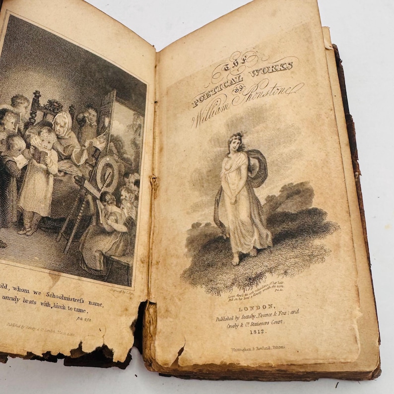May include: Open antique book with aged, yellowed pages. The left page features a detailed black and white illustration of a school scene. The right page displays the title "POETICAL WORKS of William Wordsworth" and a drawing of a woman in a flowing gown.