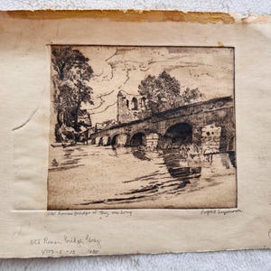 May include: An antique etching of the Old Roman Bridge at Trey, with the text "Old Roman Bridge, Trey" and "4109-5-13" visible. The artwork depicts a stone bridge over water, with trees and buildings in the background. The print is on aged paper.