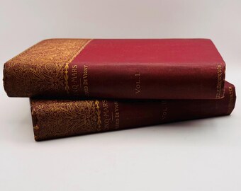 May include: Two antique books stacked on top of each other. The books have burgundy covers with gold-colored decorative patterns on the spine and edges. The text "CINQ-MARS" and "FRED DE VIGNY" is visible on the spine.