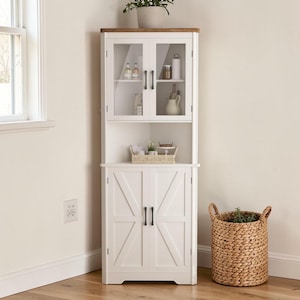 May include: A white corner cabinet with glass-fronted upper doors and solid lower doors. The cabinet has a wooden top and black hardware. A woven basket and a potted plant are nearby.