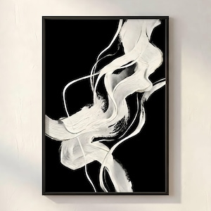 May include: Abstract art print in a black frame. The artwork features bold white brushstrokes against a black background, creating a dynamic and flowing composition. The design includes thick, textured strokes and thin, linear elements.