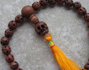 Pocket mala with carved wood lutong beads and yellow tassel