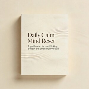 Peut inclure: Un livre à couverture rigide crème intitulé "Daily Calm Mind Reset". Le sous-titre est : "A gentle reset for overthinking, anxiety, and emotional overload." La couverture présente un motif de vagues.