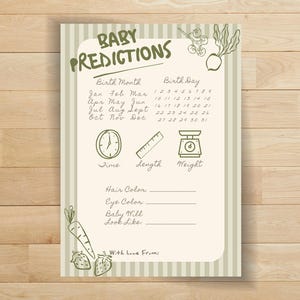 May include: A beige baby prediction card with green text and illustrations. The card includes sections for birth month, birth day, time, length, and weight. It also has spaces for hair and eye colour, baby mill, and look-alike predictions.