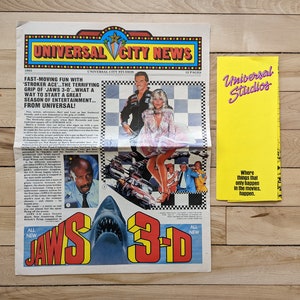 May include: A vintage newspaper advertisement for Jaws 3-D at Universal Studios. The ad features a shark, a couple, and the text "All New Jaws 3-D".