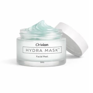 May include: A clear glass jar of "Hydra Mask" facial peel by Orivion. The jar contains a light blue gel, with the lid resting beside it. The jar is labeled "50G".