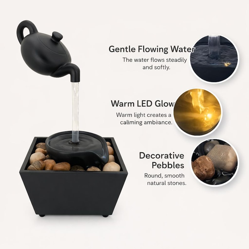 May include: Black tabletop water fountain with a teapot-shaped spout. Water flows into a basin above a square container filled with decorative pebbles. The image includes text describing the fountain's features.