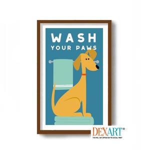 May include: A framed print with a cartoon dog illustration. The dog is yellow and sitting on a stack of towels in front of a light blue towel. The words "WASH YOUR PAWS" are at the top of the print in white letters.