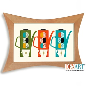 May include: A framed print featuring three colorful teapots in green, orange, and teal, each with a matching cup below. The teapots have a retro design with geometric shapes. The frame is made of light-colored wood.