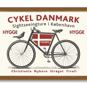May include: A vintage-style poster advertising bicycle tours in Copenhagen, Denmark. The poster features a black bicycle with a red and white Danish flag on the side, the words "CYKEL DANMARK Sightseeingture i København", and the word "HYGGE" on either side of the bicycle. The poster also includes the words "Christiania Nyhavn Strøget Tivoli" at the bottom.