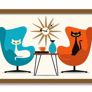May include: A framed print featuring a mid-century modern design. Two egg chairs, one teal and one orange, flank a small table with a starburst clock above. A white cat sits in the teal chair, and a black cat sits in the orange chair.