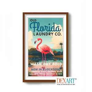 May include: A vintage-style poster advertising "Old Florida Laundry Co." with a pink flamingo standing in a body of water. The poster has a blue sky with white clouds and palm trees. The text "Wash Dry Fold" and "Now in 8 Locations" is printed on the poster.