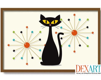 May include: A framed print featuring a stylized black cat with yellow eyes, set against a cream background. Two starburst designs with orange, blue, green, and black accents flank the cat. The frame is brown.