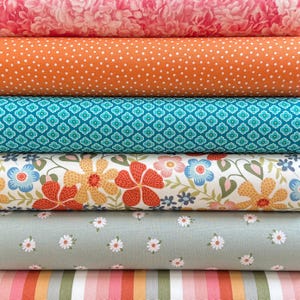 May include: A stack of six fabric bolts featuring diverse patterns: a pink floral print, an orange fabric with white polka dots, a teal geometric motif, a white background with large orange and blue flowers, a sage green with small white daisies, and vertical stripes.