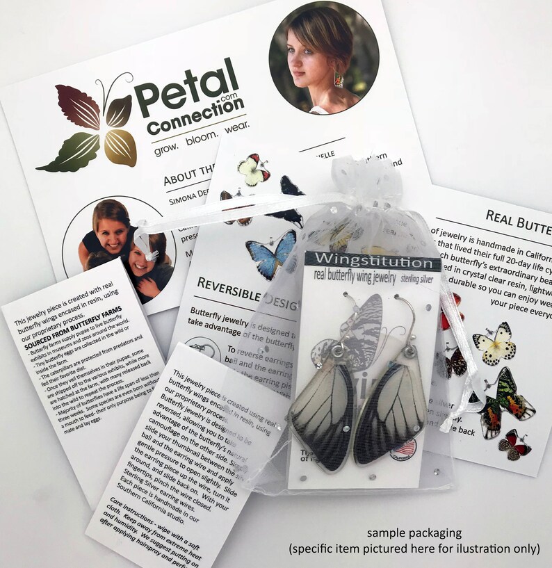 May include: A pair of sterling silver earrings with real butterfly wings encased in clear resin. The earrings are reversible, allowing you to wear the wings on either side. The packaging includes a small bag and a card that reads "Wingstitution real butterfly wing jewelry sterling silver".