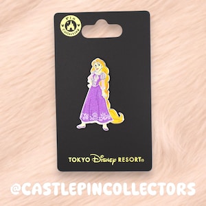 Könnte beinhalten: Anstecknadel mit Rapunzel aus Disney's Rapunzel, in einem lila Kleid und mit langen blonden Haaren. Die Anstecknadel befindet sich auf einer schwarzen Rückwandkarte mit dem Logo des Tokyo Disney Resort und einem Pin-Sammellogo.