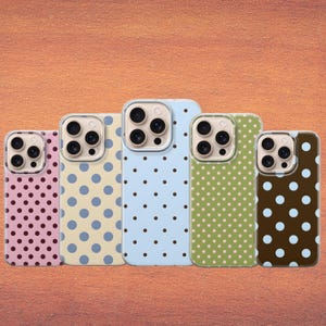 May include: Five mobile phone cases with polka dot designs. The cases are in shades of pink, yellow, light blue, green, and brown. The polka dots are in contrasting colours, such as blue, brown, and pink.