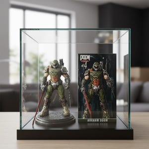 May include: A Doom Eternal action figure and its packaging are displayed inside a glass case. The figure is green and brown, holding a red weapon. The packaging reads "DOOM Eternal #4" and "ARKHAM DOOM".