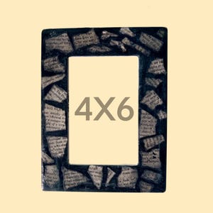 May include: A rectangular picture frame with a dark border decorated with a collage of torn newspaper clippings featuring black text on off-white paper. The center of the frame displays the text 4X6 in a large, centered, grey sans-serif font.