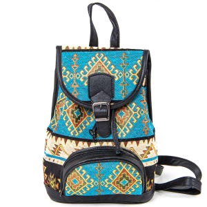 May include: A small backpack with a turquoise, black, and tan geometric pattern. The bag has a black leather flap with a buckle closure, a small front pocket, and black straps. The top handle is also black.