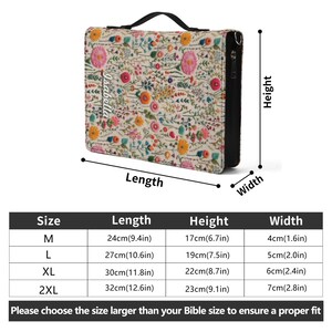 May include: A rectangular Bible cover featuring a cream-colored fabric with a colorful embroidered floral pattern and the name Isabella printed on the front. It includes a black handle, a zipper, and a size chart with dimensions in inches and cm.