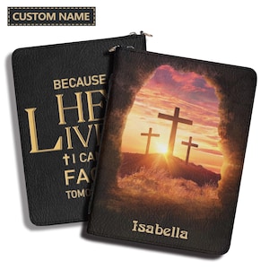 May include: Two black rectangular covers with zippers. One features the gold text "BECAUSE HE LIVES I CAN FACE TOMORROW" and the other displays a sunset scene with three crosses viewed from a cave opening, with the name "Isabella" printed in gold.