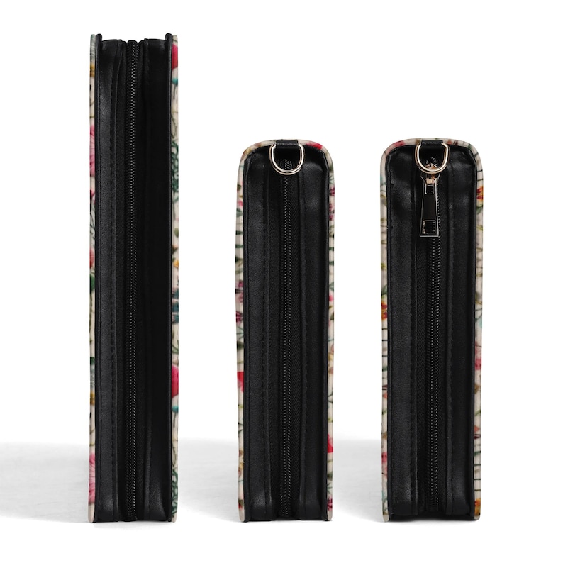 May include: Three rectangular cases of varying heights, each featuring a floral pattern with red, pink, and green tones. The cases have black side panels, black zippers, and metallic hardware attachments at the top for carrying straps.