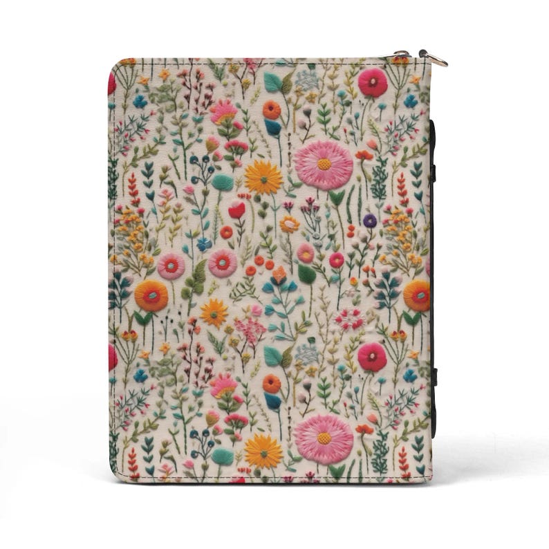 May include: A rectangular zippered case featuring an off-white fabric exterior with a dense, colorful embroidered pattern of various wildflowers, including pink, orange, yellow, and blue blossoms, along with green stems and leaves.