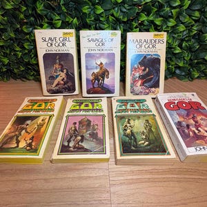 May include: Seven paperback books from the Gor series by John Norman, including Slave Girl of Gor, Savages of Gor, Marauders of Gor, Priest-Kings of Gor, Tarnsman of Gor, Captive of Gor, and Renegades of Gor, featuring colorful cover illustrations.