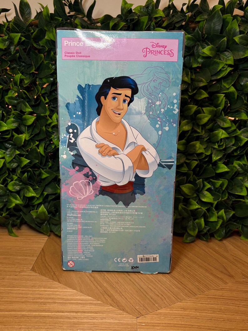 May include: A Disney Princess Prince classic doll box. The box features a cartoon illustration of Prince, with the text "Prince" and "Classic Doll" in English and French. The Disney Princess logo is visible.