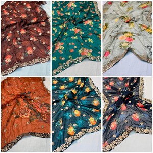 May include: A collection of six floral-patterned scarves in various colors, including brown, green, orange, and black. Each scarf features a vibrant floral design with gold trim along the edges. The fabric appears to be lightweight and flowing.