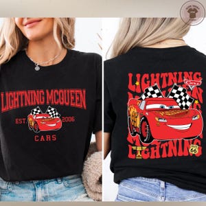 a woman wearing a black t-shirt with a graphic of Lightning McQueen and the text "Lightning McQueen" printed on it.
