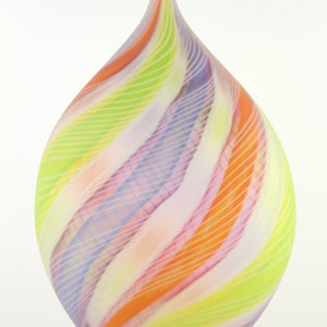 May include: A colorful glass vase with a teardrop shape. The vase features a swirl design of pastel colors including orange, pink, yellow, and purple. Thin white lines accent the design, creating a unique decorative piece.