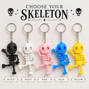May include: Five skeleton keychains in black, white, pink, blue, and yellow, each with a metal ring and chain. The text CHOOSE YOUR SKELETON appears at the top, with labels for each color below. The skeletons have articulated limbs and heads.