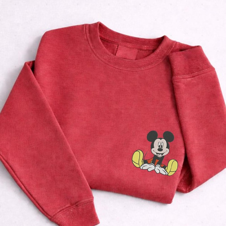 A red sweatshirt with a cartoon character printed on the front.