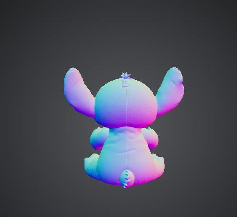 May include: A plush toy in the shape of a blue and pink alien character, with large ears and a small tail. The toy is sitting down, with its back facing the viewer. The toy has a small tuft of hair on its head.