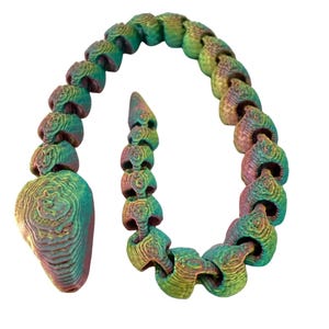 May include: A segmented, articulated sculpture in shades of green, blue, and purple. The piece has a textured, organic appearance, resembling a stylized snake or chain. The design is set against a clean white background.