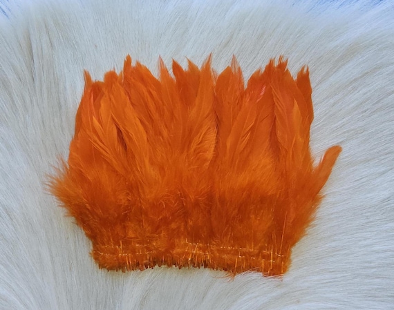 Schalppen Saddle Hackle.. Fly Tying Feather. Schalppen Hackle (Feather) 6" Strip, 15 cm... Color;  Orange., H-62