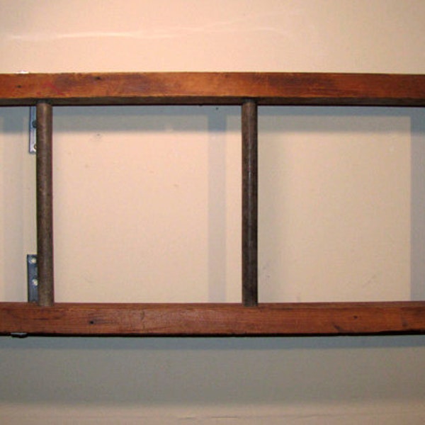 Antique wooden ladder bookshelf with metal rungs