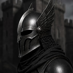 May include: A dark metallic helmet featuring a central ridge, a visor with vertical openings, and prominent wing-shaped attachments on the sides. The helmet includes a chainmail neck guard and is worn over a dark fabric cowl and shoulder armour.