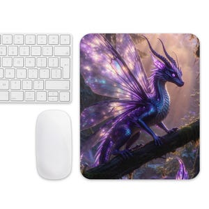 May include: A computer mouse pad featuring a fantasy dragon with purple and blue scales, perched on a tree branch. The dragon has large, iridescent wings and is set against a backdrop of a forest scene. A white keyboard and mouse are in the image.
