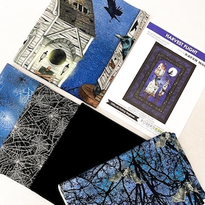 May include: A collection of Halloween-themed fabric and a quilt pattern. The fabric features spiderwebs, bats, and a haunted house design. The quilt pattern is titled "Harvest Flight" and features a raven and a full moon.