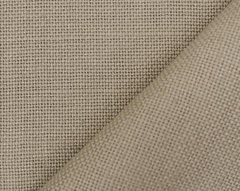 May include: Close-up of a beige linen fabric with a woven texture. The fabric is folded diagonally, revealing a layered effect. The neutral color and natural fibers suggest a textile suitable for various crafting or home decor projects.