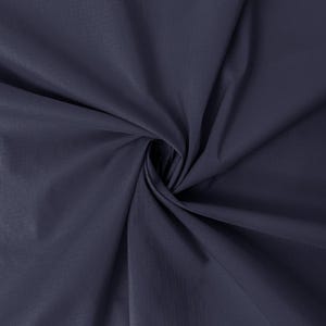May include: A close-up shot of a navy blue fabric with a subtle sheen. The fabric is tightly swirled in the center, creating a spiral effect. The material appears smooth and possibly lightweight, with soft folds and shadows.