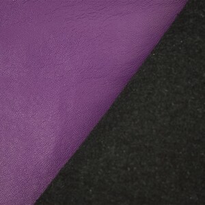 May include: A diagonal split image showcasing two distinct textures. The left side displays a smooth, textured, purple surface. The right side features a dark, rough, black material. The contrast highlights the difference in textures.