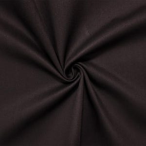 May include: Close-up of a dark brown fabric with a swirling pattern. The fabric appears to be smooth and has a slight sheen, with the light reflecting off the folds. The overall texture is soft and inviting.