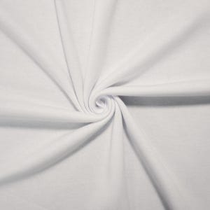 May include: A solid white fabric with a smooth, matte texture, arranged in a central spiral swirl pattern that creates soft, radiating folds and shadows across the surface, highlighting the clean, uniform color and consistent weave of the material.