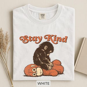 May include: A set of three ceramic mugs with a speckled, matte finish. The mugs are in shades of cream, light gray, and dark gray. Each mug has a simple, minimalist design and a rounded handle.