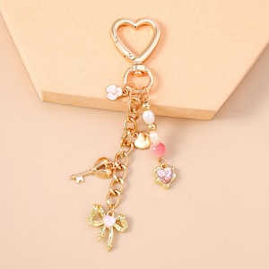 リボンと鍵のアクセントが付いたゴールデンハートチャームキーホルダー、カップルキーホルダー、財布用キーホルダー、バレンタインデーギフト