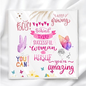 May include: A square, white print with motivational text and butterfly illustrations. The text includes phrases like "Focus!", "Behind Every Successful Woman is Herself", and "You Can". Butterflies are pink, purple, and orange.